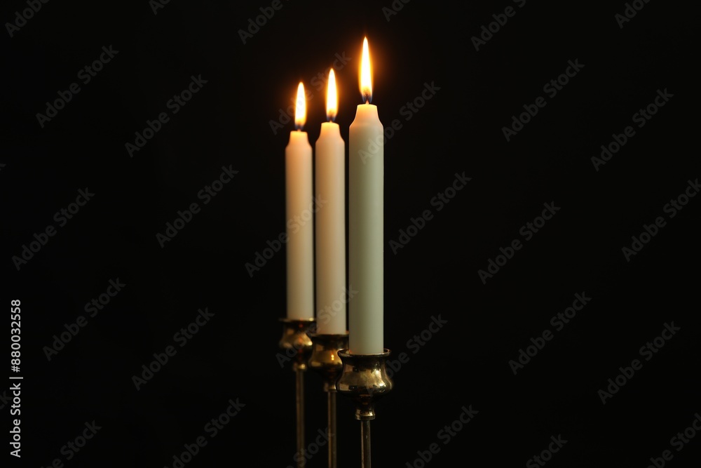 Burning candles on black background. Space for text Burning candles on black background. Space for text