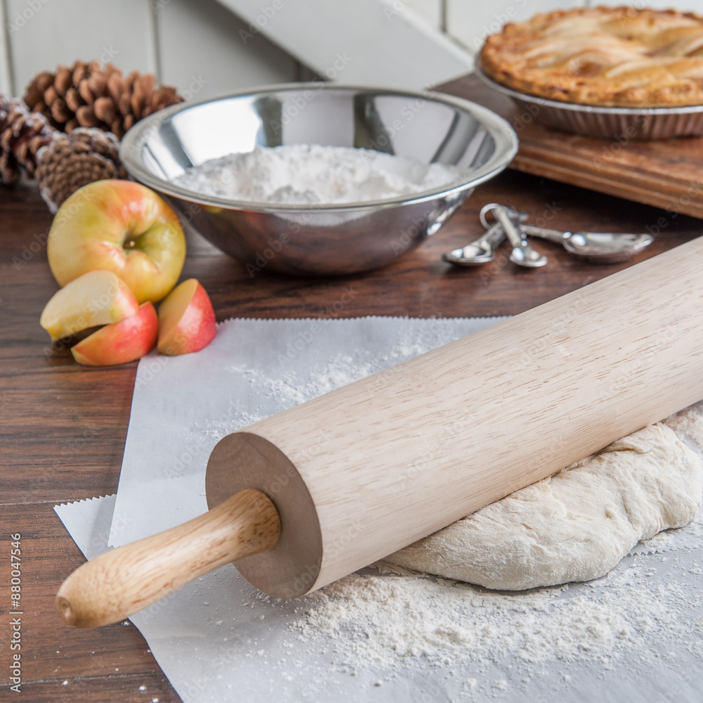 Apple pie ingredients with rolling pin and dough on a wooden table Apple pie ingredients with rolling pin and dough on a wooden table