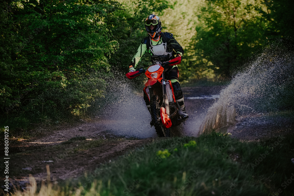 Professional enduro bike rider on action, dirt ride on the muddy road. Motocross sport. Professional enduro bike rider on action, dirt ride on the muddy road. Motocross sport.