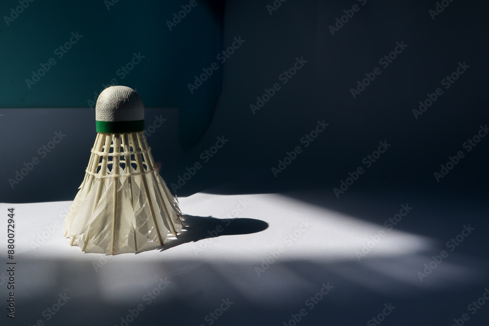 Shuttlecock on a dark background with shadows from morning sunlight. Shuttlecock on a dark background with shadows from morning sunlight.