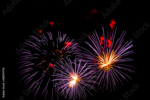 Montreal, Canada - June 27 2024: Fire works show with quarter moon in background at La Ronde in Montreal
