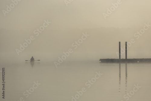 Kayaker at sunrise in the morning fog  Busse Woods, Elk Grove Village photo