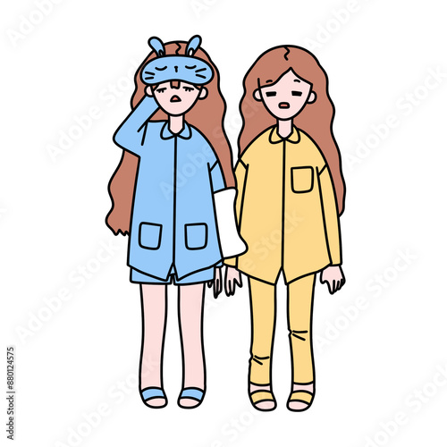 Two girls are wearing pajamas and one of them is holding the other one