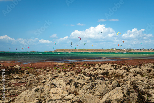 View of the coast of the city with beaches and kitesurfing enthusiasts on a sunny summer day, Saint-Malo, Brittany, France