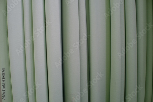 Fototapeta Naklejka Na Ścianę i Meble -  The light green cloth curtain functions as a room divider 