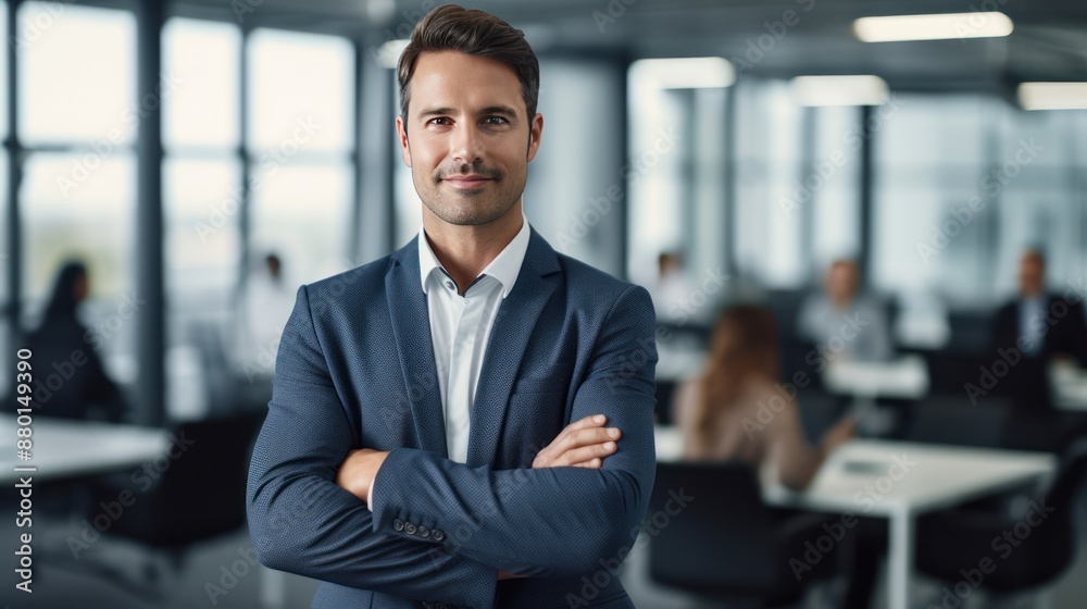 A successful business professional stands confidently with arms crossed A successful business professional stands confidently with arms crossed
