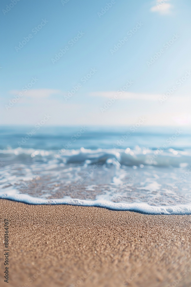 Close-up of gentle waves on a sandy beach with a clear blue sky, evoking tranquility and peace. Close-up of gentle waves on a sandy beach with a clear blue sky, evoking tranquility and peace.