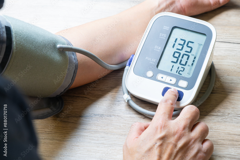 Man checks blood pressure monitor and heart rate monitor with digital pressure gauge. Health care and Medical concept.
Man checks blood pressure monitor and heart rate monitor with digital pressure gauge. Health care and Medical concept.