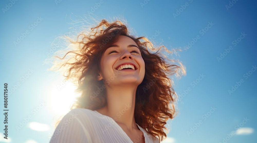 Young woman with a toothy smile With a bright sky background Young woman with a toothy smile With a bright sky background