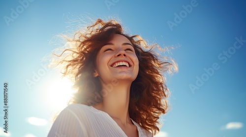 Young woman with a toothy smile With a bright sky background