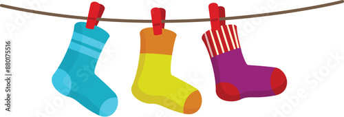 Three colorful socks hanging on clothesline after laundry