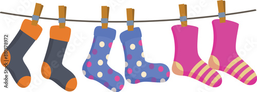 Colorful socks hanging on clothesline after laundry