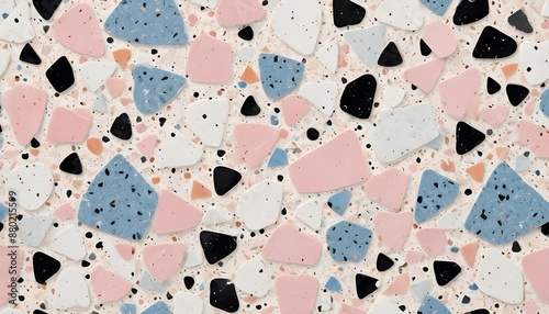 A close-up image of terrazzo tiles with various shapes and sizes of pink, blue, black, and white