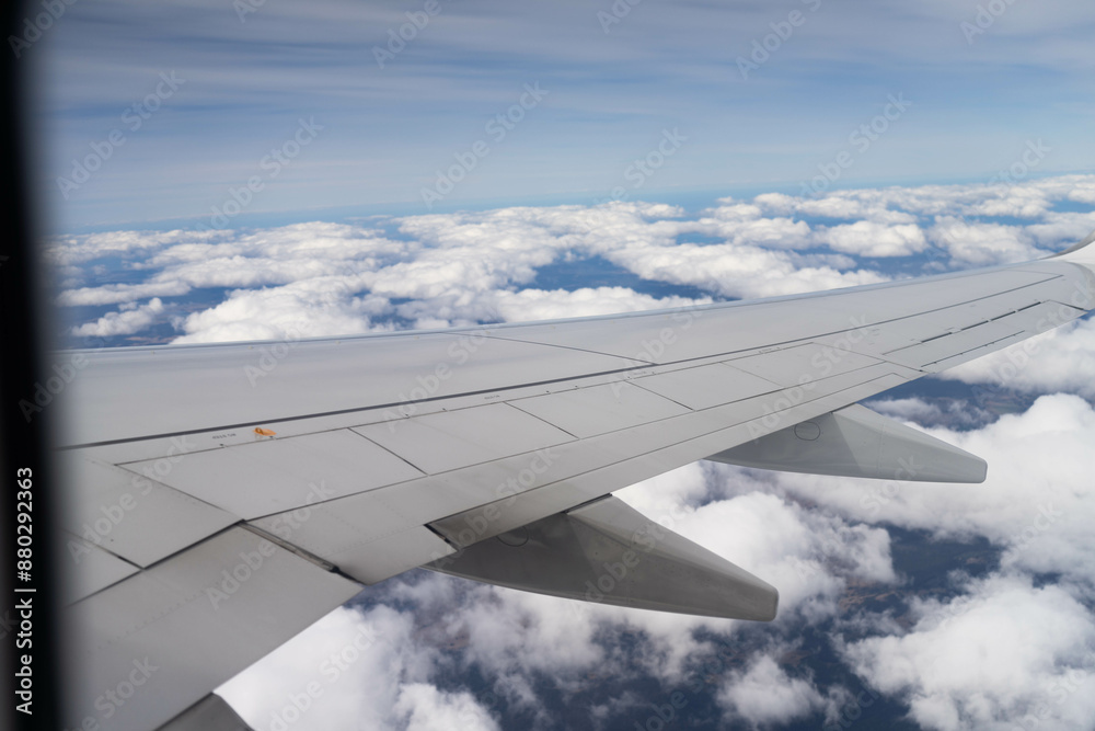 looking out plane window at the clouds above australia over the wing looking out plane window at the clouds above australia over the wing