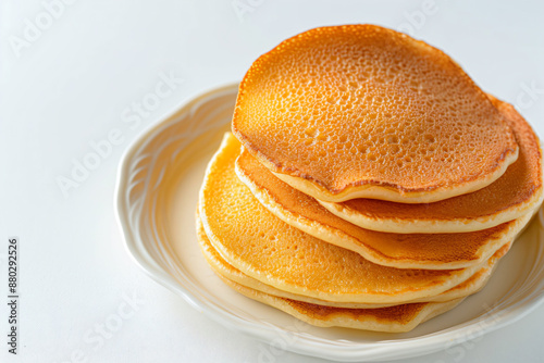 a stack of pancakes on a plate on a table photo