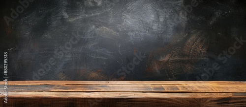 Wooden plank table with copy space image for showcasing products, ideal for interior design or displaying items against a blank blackboard background, perfect for educational purposes.