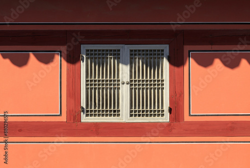 Front view of red wall and window door with wood muntin on a tile house of Changgyeonggung Palace near Jongno-gu, Seoul, South Korea
 photo