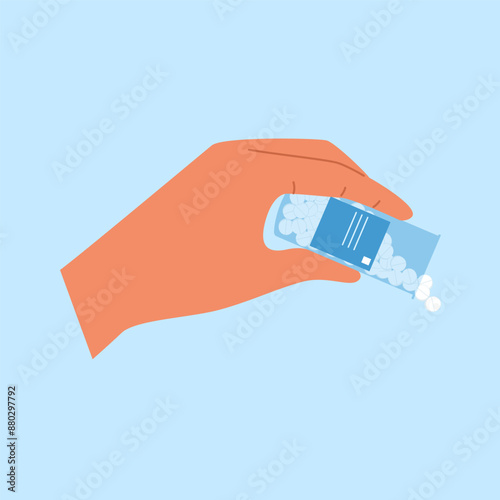 Hand spilling out  pills of the bottle. Medicine capsules fall out of the pill container