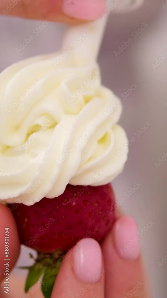 girl holding strawberry in hand close-up adding cream from spray can tasty treat. Yogurt Pouring from Top over a Strawberry girl holding strawberry in hand close-up adding cream from spray can tasty treat. Yogurt Pouring from Top over a Strawberry