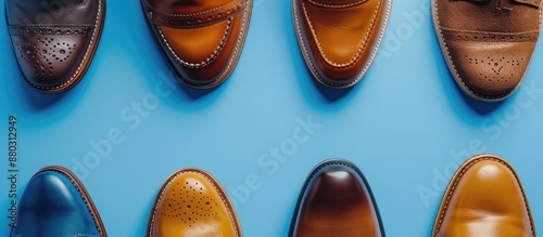 Stylish shoes displayed on a blue backdrop from a top-down perspective with room for text in the image. photo