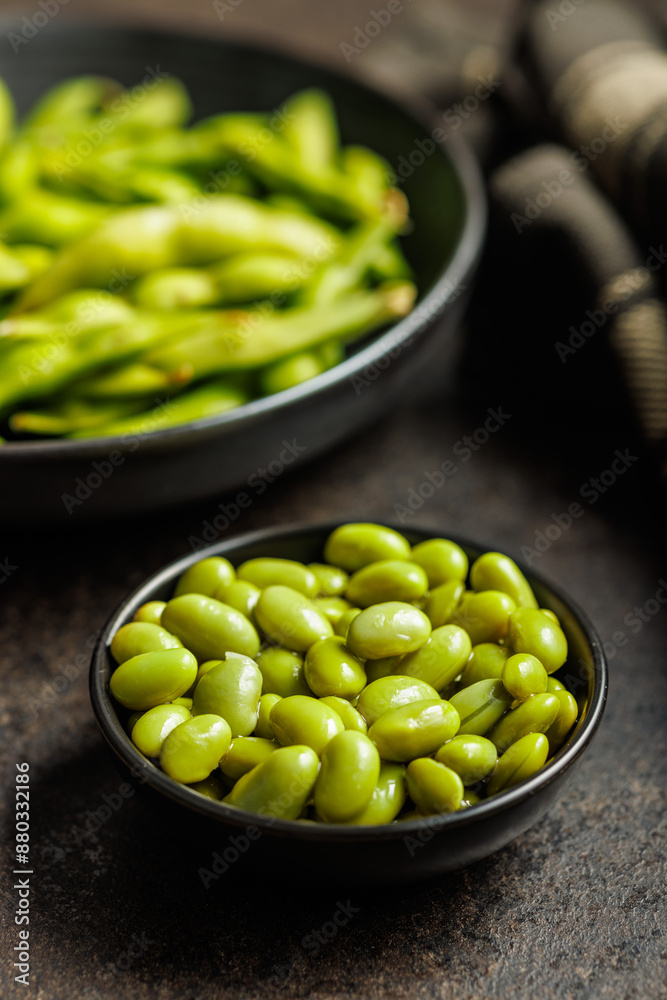 Green edamame pods. Fresh soybeans in bowl on black table. Green edamame pods. Fresh soybeans in bowl on black table.