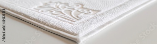 Closeup of a hotels plush bathmat with an embroidered logo, Modern, White, Digital Painting, Luxurious detail photo