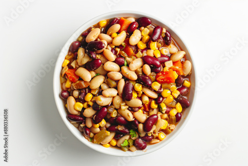 a bowl of beans and corn on a white surface