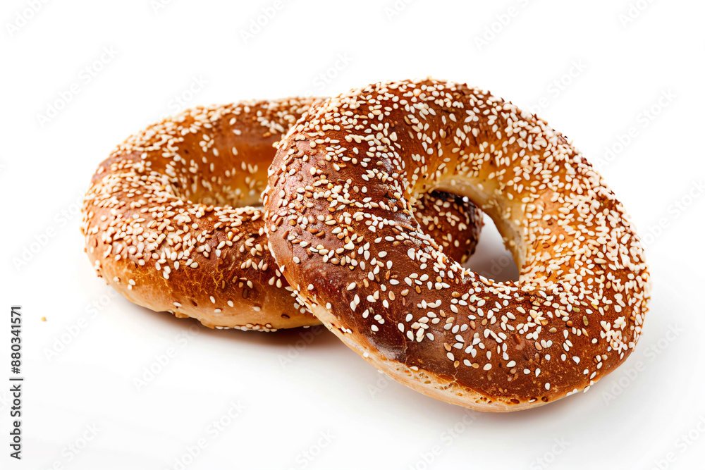 two sesame bagels with sesame seeds on a white background two sesame bagels with sesame seeds on a white background