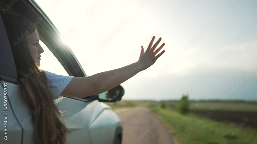 Young girl leans out car window feeling freedom open road. Girl road ...