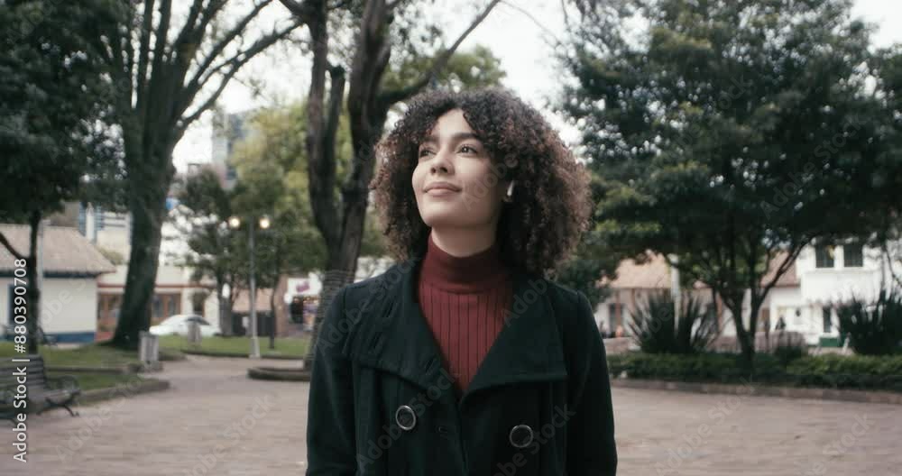 Woman in a suit with curly hair walks seeing around in the city of Bogota, Colombia Woman in a suit with curly hair walks seeing around in the city of Bogota, Colombia