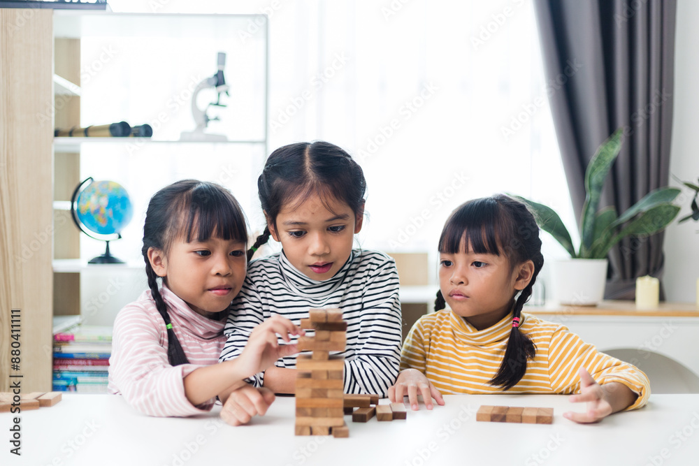 three sibling Asian girl playing wooden stacks at home three sibling Asian girl playing wooden stacks at home