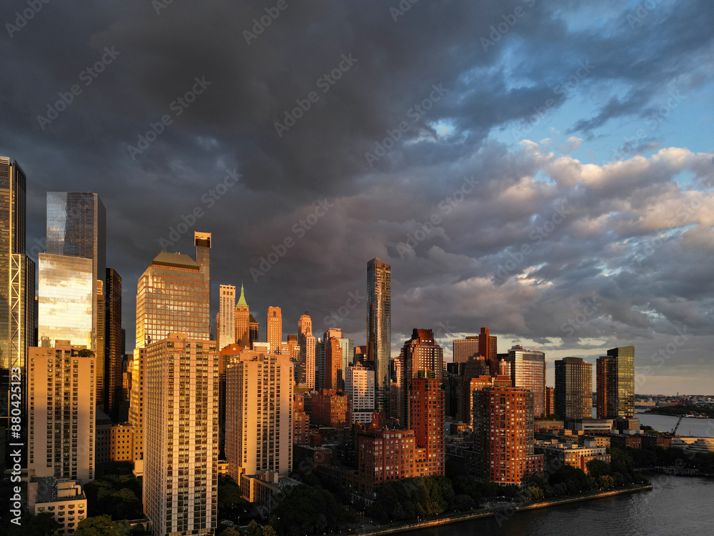 Naklejka premium New York City top view. NYC aerial view, New York City Skyline with dramatic sky. Panoramic drone view on Manhattan in NY. Sunset in NYC. New York City Midtown skyline view at dusk with clouds.