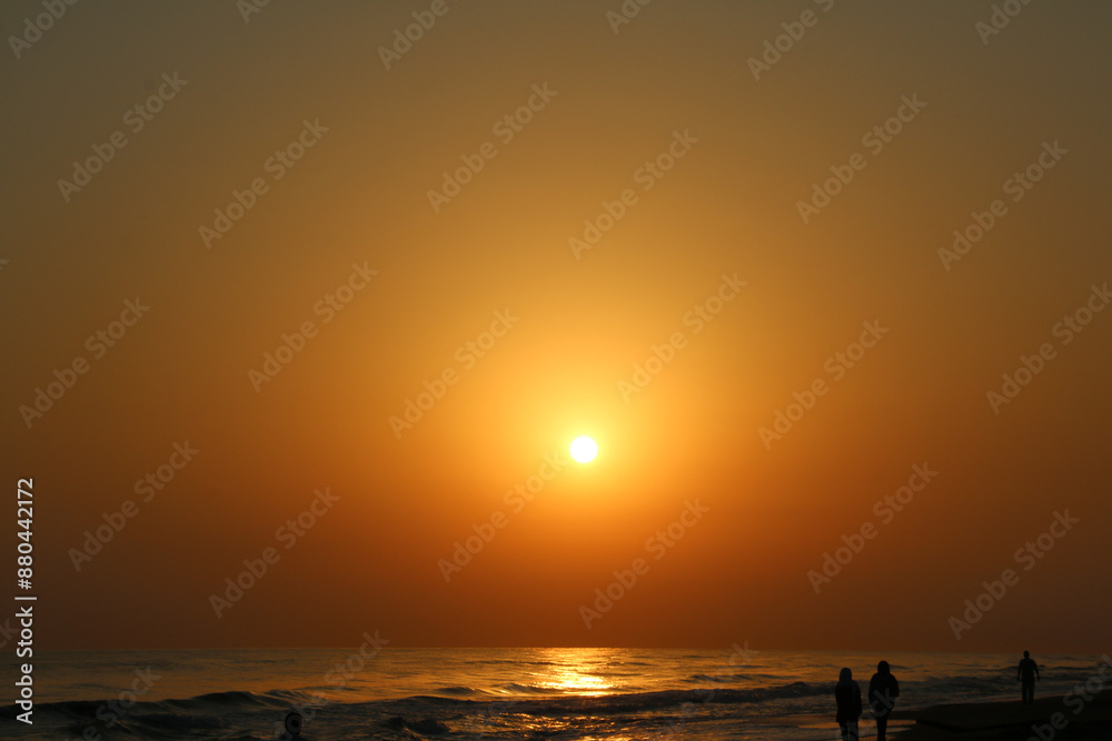 Sunset's Glow, Painting the Sky with Golden Hues above the Sea, The sunset above the sea, Sunset on the beach, beach, sunset, people Sunset's Glow, Painting the Sky with Golden Hues above the Sea, The sunset above the sea, Sunset on the beach, beach, sunset, people