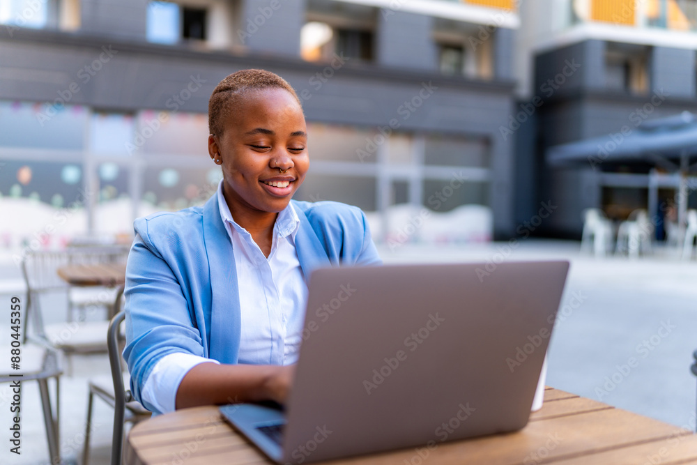 A manager works remotely using a laptop while sitting outside and making a business plan A manager works remotely using a laptop while sitting outside and making a business plan
