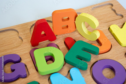 ABC puzzle, wooden alphabet letters puzzle board for kids. Colorful close-up view of ABC letters, early childhood educational toy for learning and development. Montessori toy. High-Quality image.  photo