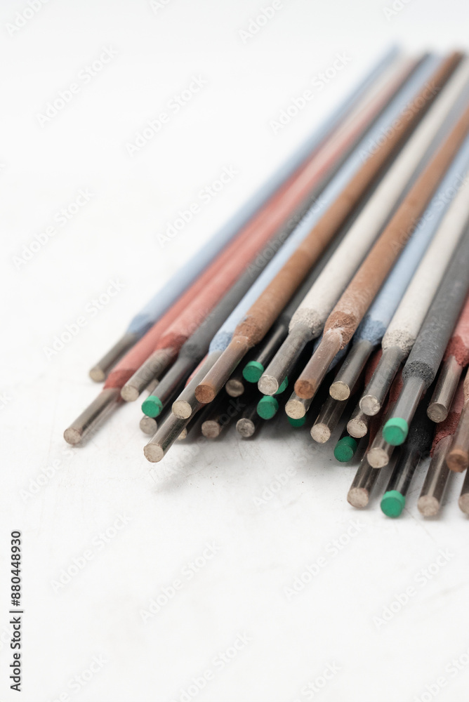 Various colorful welding electrodes/ rods on white background for Industrial and metalworking applications. For welding applications and work. Close- up.