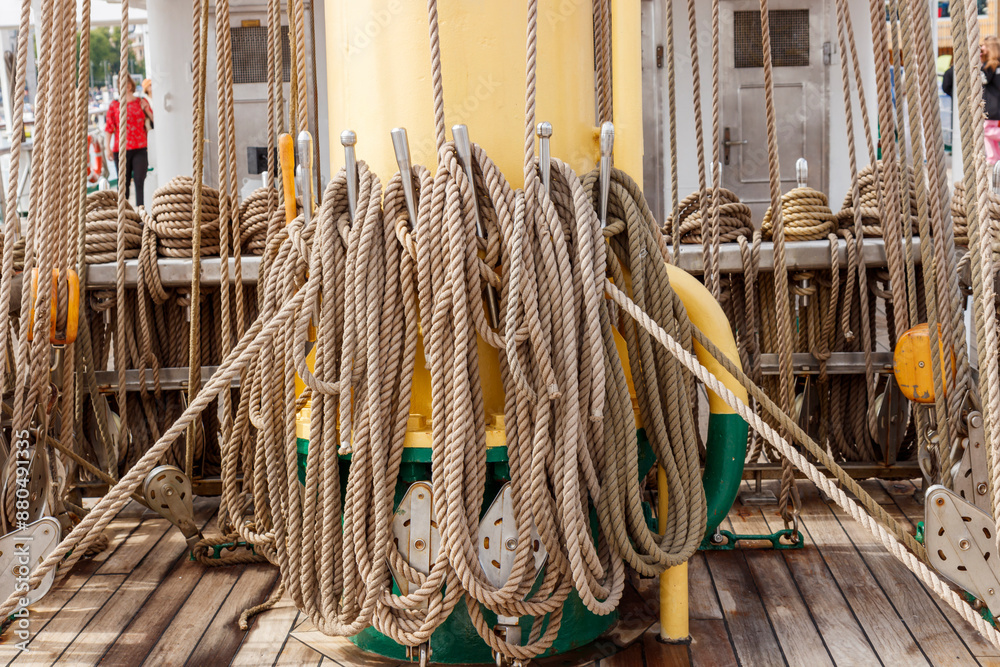 Neatly coiled ropes on the deck of a traditional sailing ship, resting ...