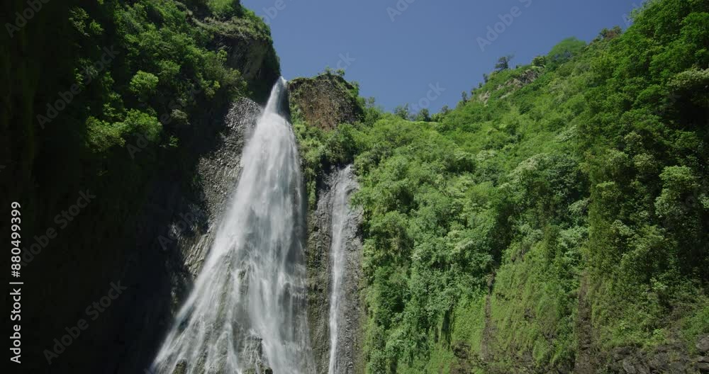 Tilt shot on beautiful waterfall on Hawaiian cliffside Tilt shot on beautiful waterfall on Hawaiian cliffside