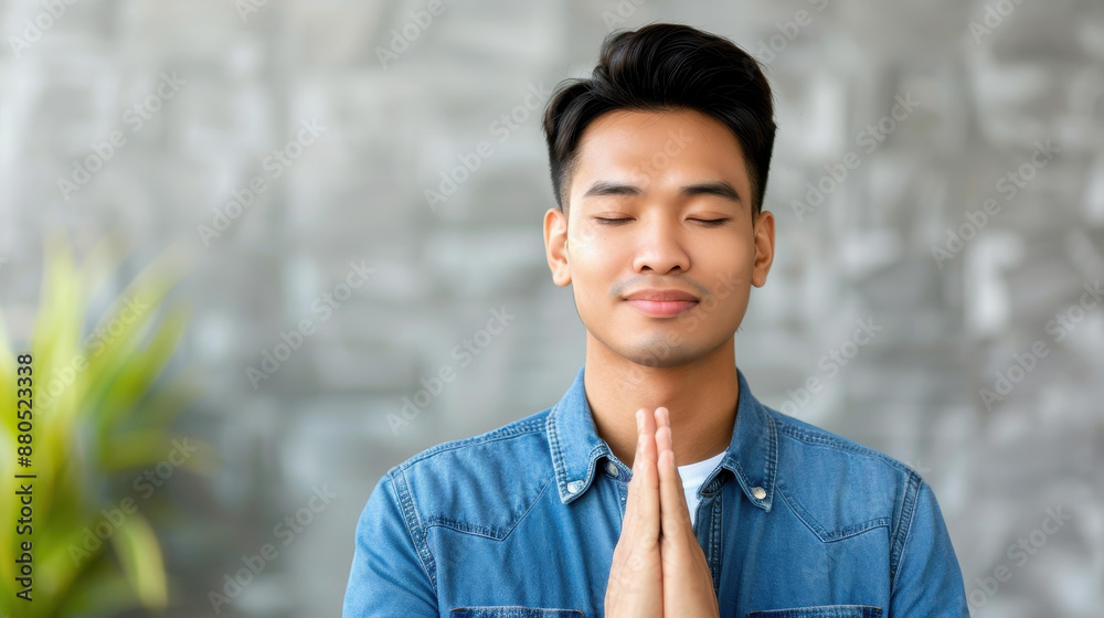 Faithful young man praying on a sofa, seeking luck, success, and forgiveness in his home office. Power of religion and worship. Faithful young man praying on a sofa, seeking luck, success, and forgiveness in his home office. Power of religion and worship.