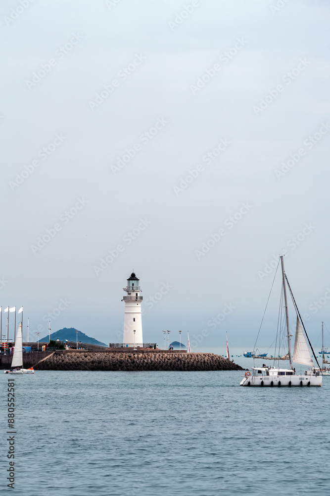 Tranquil Lighthouse and Sailboats on a Calm Sea Tranquil Lighthouse and Sailboats on a Calm Sea