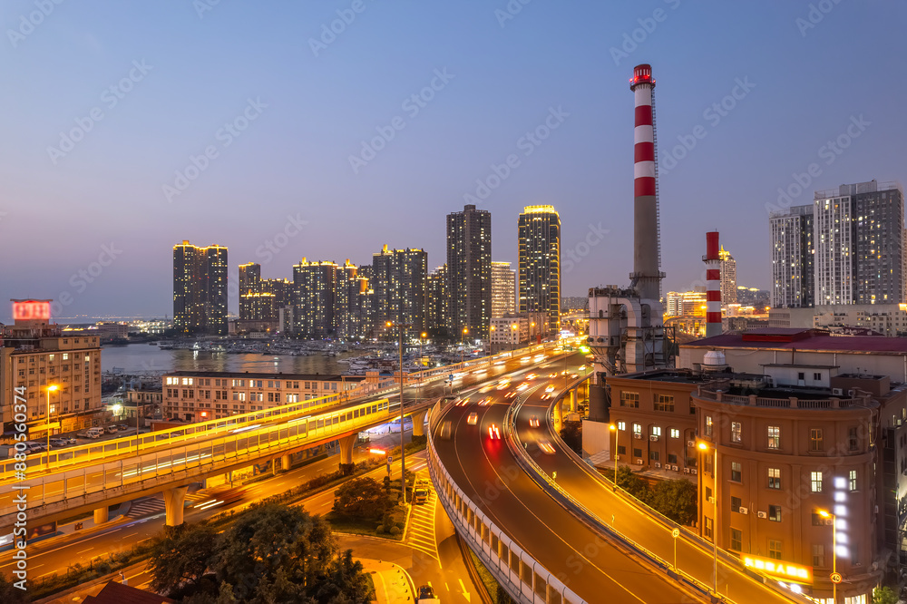 Fototapeta premium Vibrant Urban Cityscape with Illuminated Highways and Skyscrapers