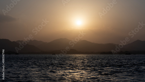 Tranquil Sunset Over Mountainous Lake Horizon