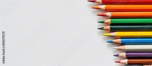 Colorful pencils for drawing supplies on a white background symbolizing an educational theme with available copy space image