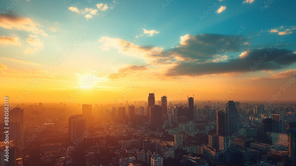 Fototapeta premium Sunset view of city skyline tall buildings clouds blue sky background Panoramic aerial landscape washed out color grading in golden hour lighting