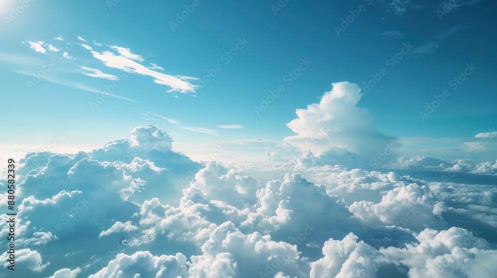 Blue sky with fluffy white clouds sun shining brightly in background from above looking down at vast expanse of clouds Blue sky with fluffy white clouds sun shining brightly in background from above looking down at vast expanse of clouds