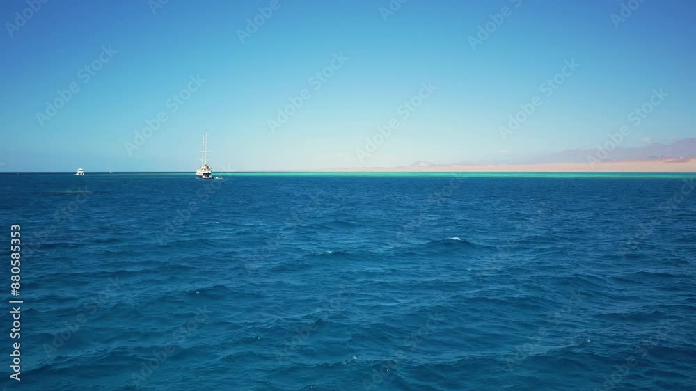 The ship is standing in the harbor in the beautiful blue sea. The ship is standing in the harbor in the beautiful blue sea.