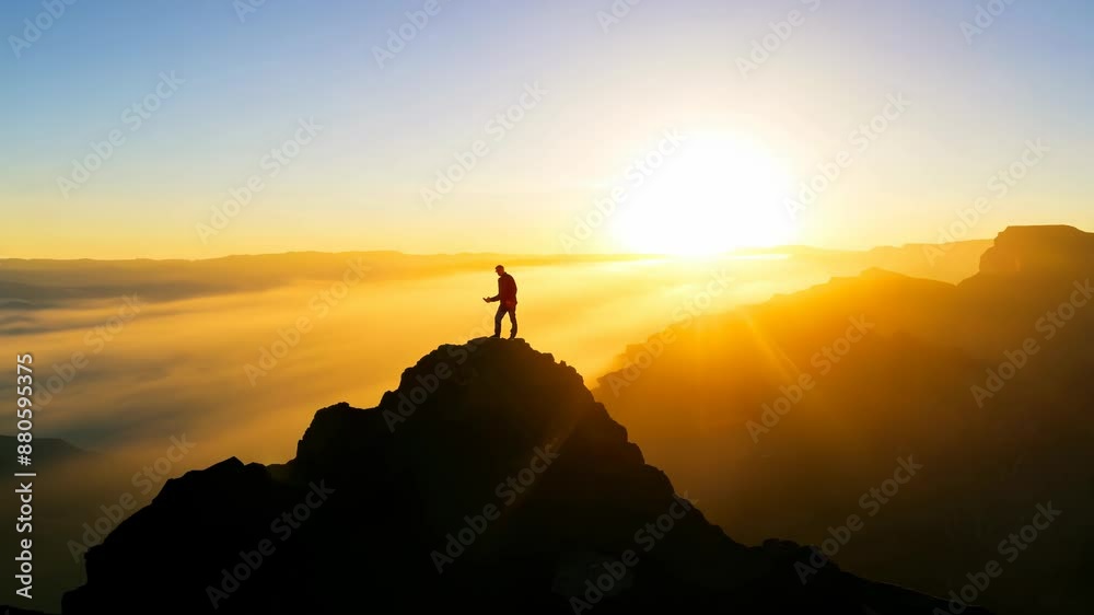 Silhouette of a Hiker on Mountain Peak at Sunset Silhouette of a Hiker on Mountain Peak at Sunset