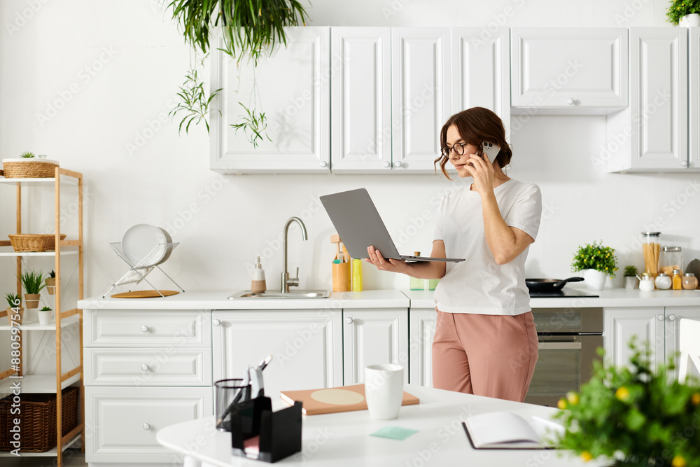 Middle-aged woman talking on phone, holding laptop. Middle-aged woman talking on phone, holding laptop.