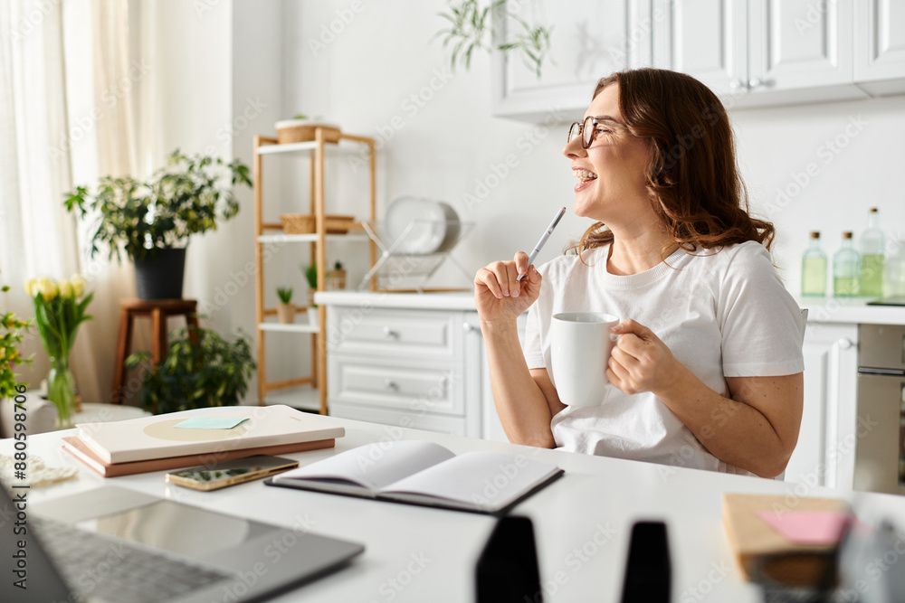 Middle aged woman sitting at desk with coffee. Middle aged woman sitting at desk with coffee.