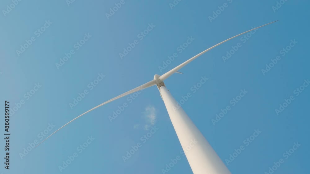 A serene scene of windmill farm turbines on a mountain demonstrates clean energy innovation. Modern technology supports sustainable development under the endless blue sky. A serene scene of windmill farm turbines on a mountain demonstrates clean energy innovation. Modern technology supports sustainable development under the endless blue sky.
